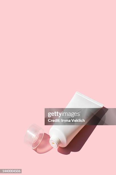 tube with beauty product facial cream or hand cream, lotion, shampoo on pastel pink color background. - creme tube ストックフォトと画像
