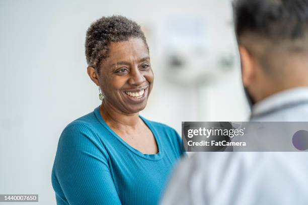 doctor meeting with a senior patient - afro caribbean ethnicity stock pictures, royalty-free photos & images