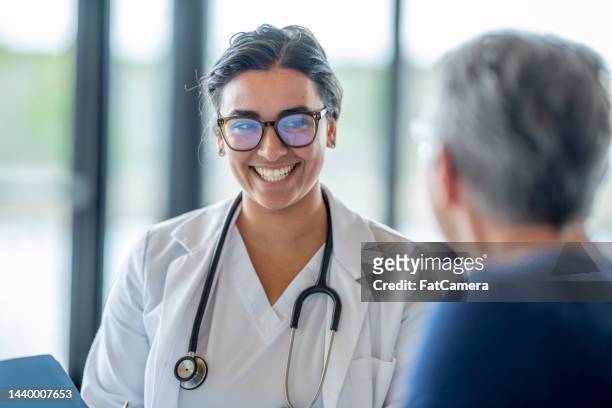 female doctor with a senior patient - general practitioner stock pictures, royalty-free photos & images