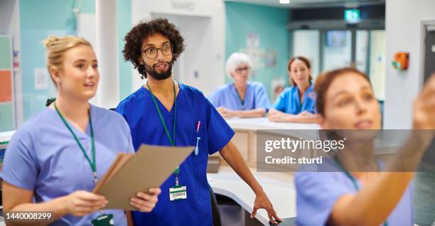 allocating beds on the ward - nurses station stock pictures, royalty-free photos & images