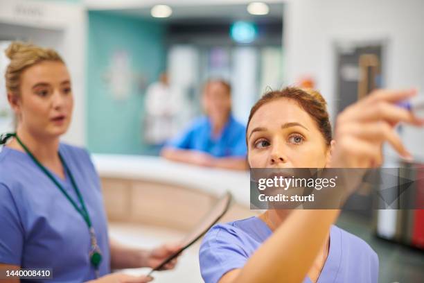 nurse station on the ward - nhs stock pictures, royalty-free photos & images