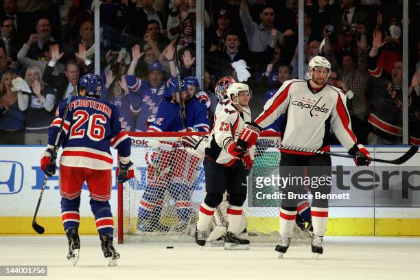 Anton Stralman of the New York Rangers celebrates with teammate Derek Stepan after scoring a goal in the first period against Braden Holtby of the...