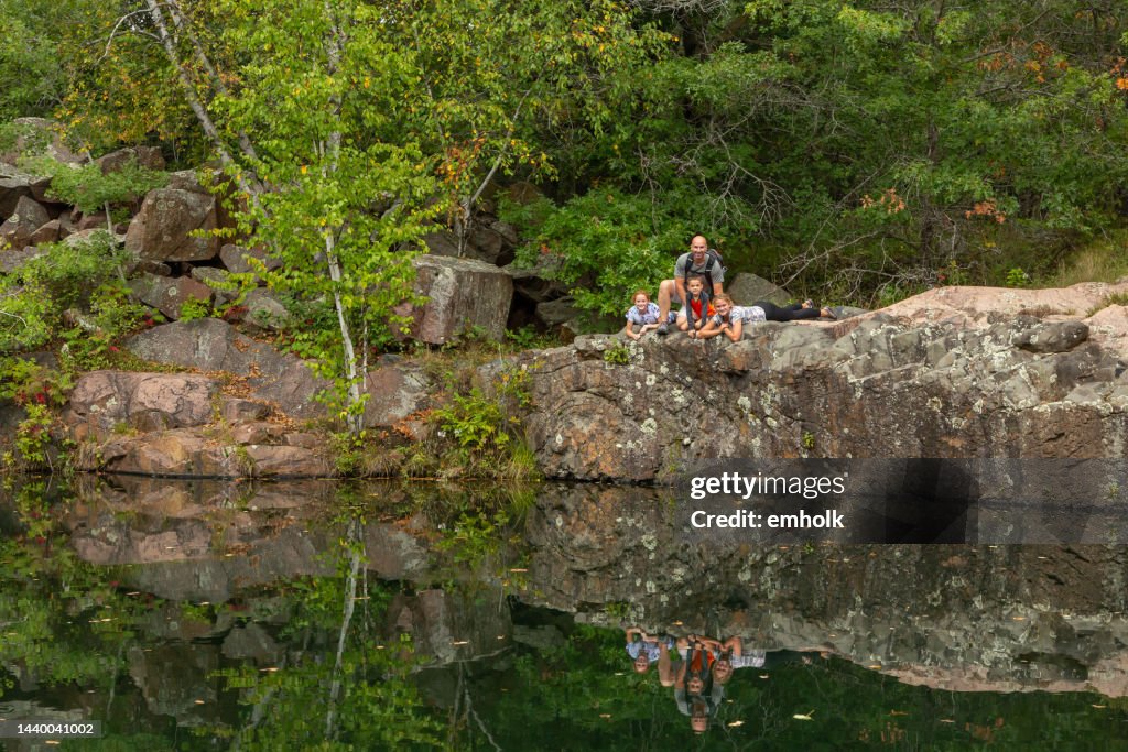 Family At Edge of Deep Granite Quarry Pond