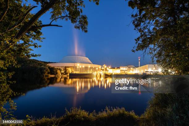 nuclear power plant next to a river at blue hour (baden-württemberg, germany) - heilbronn stock-fotos und bilder