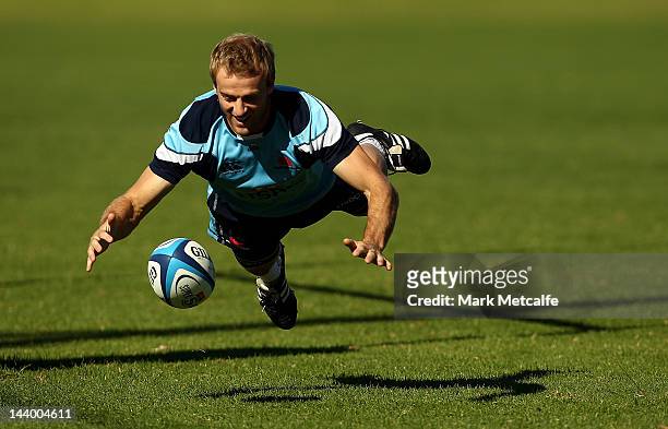 Sarel Pretorious dives for the ball during a Waratahs Super Rugby training session at Moore Park on May 8, 2012 in Sydney, Australia.