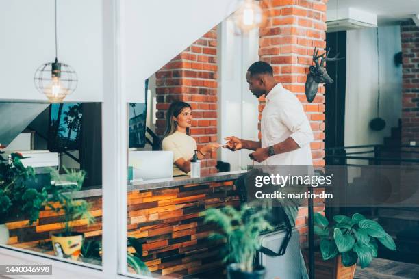 businessman checking in - hotel reopening stock pictures, royalty-free photos & images