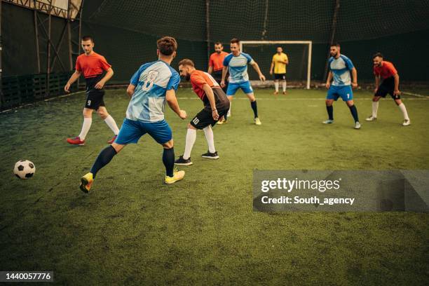 male soccer match - indoor soccer stock pictures, royalty-free photos & images