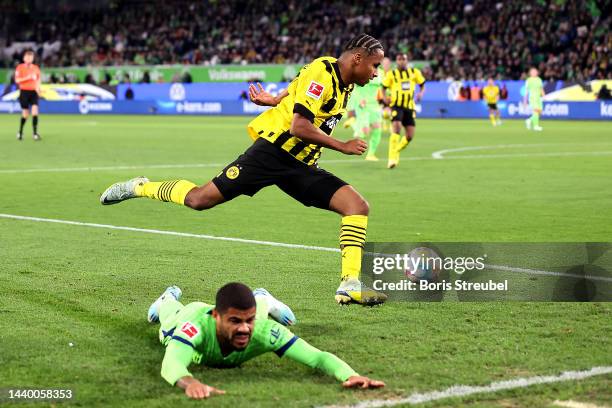 Karim Adeyemi of Borussia Dortmund gets away from Paulo Otavio of VfL Wolfsburg during the Bundesliga match between VfL Wolfsburg and Borussia...