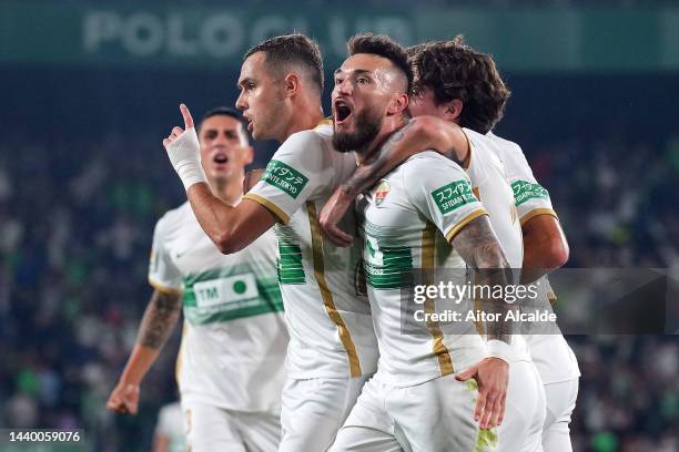 Pol Lirola of Elche CF celebrates with teammates after scoring their team's first goal during the LaLiga Santander match between Elche CF and Girona...