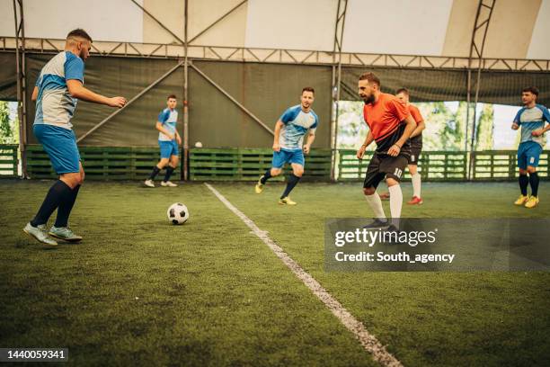 male soccer match - indoor football pitch stock pictures, royalty-free photos & images