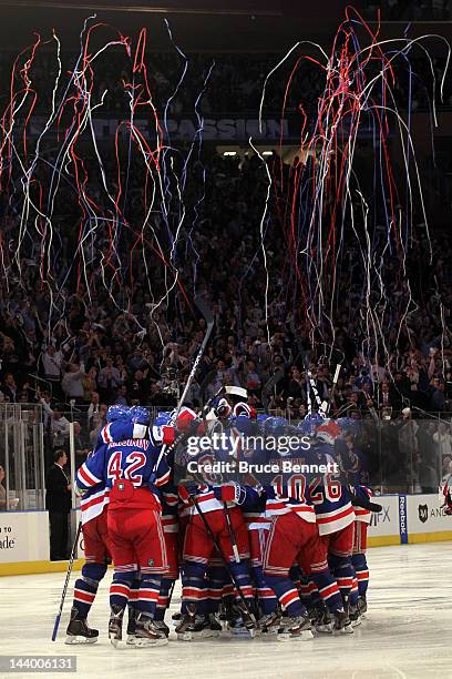 Marc Staal of the New York Rangers celebrates with his teammates after scoring the winning goal in overtime against Braden Holtby of the Washington...