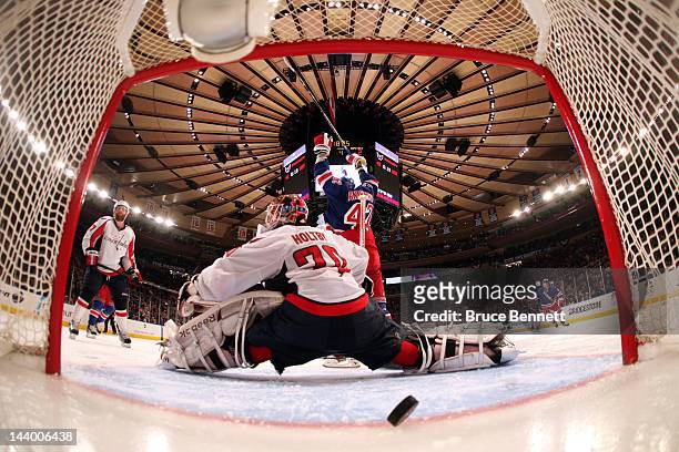 Artem Anisimov of the New York Rangers celebrates as teammate Marc Staal , scores the winning goal in overtime against Braden Holtby of the...