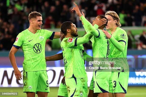 Lukas Nmecha of VfL Wolfsburg celebrates with teammates after scoring their side's second goal during the Bundesliga match between VfL Wolfsburg and...