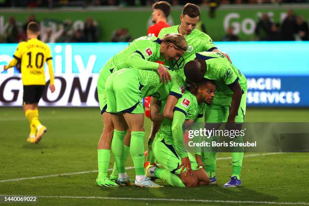 Lukas Nmecha of VfL Wolfsburg celebrates with teammates after scoring their side's second goal during the Bundesliga match between VfL Wolfsburg and...