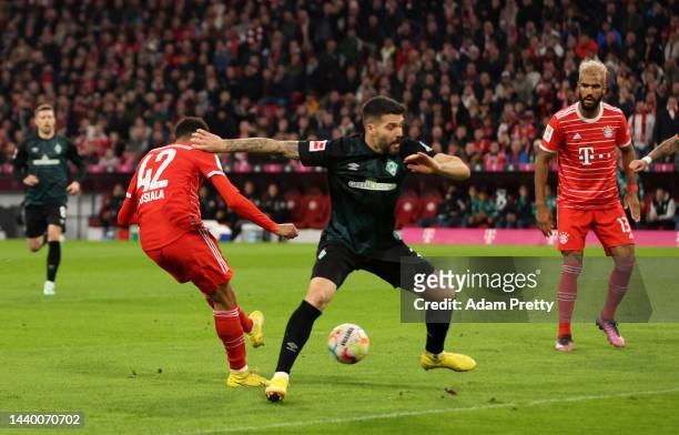 Jamal Musiala of Bayern Munich scores their team's first goal during the Bundesliga match between FC Bayern Muenchen and SV Werder Bremen at Allianz...