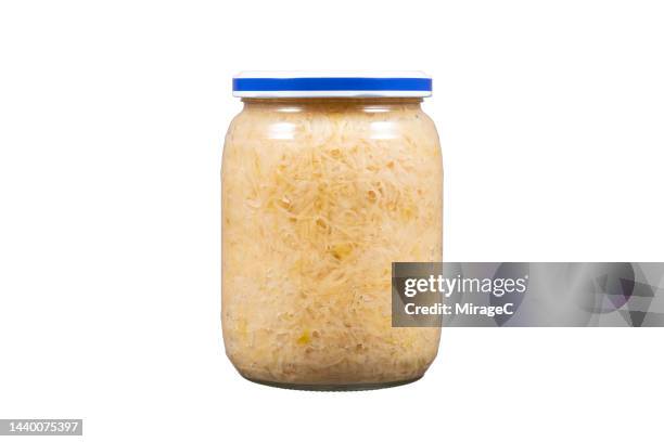 preserved fermented sauerkraut in glass jar isolated on white - sauerkraut stock pictures, royalty-free photos & images