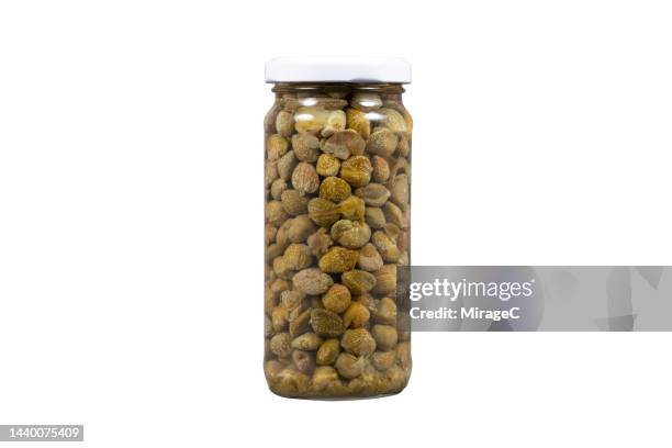 preserved capers in glass jar isolated on white - kapris bildbanksfoton och bilder