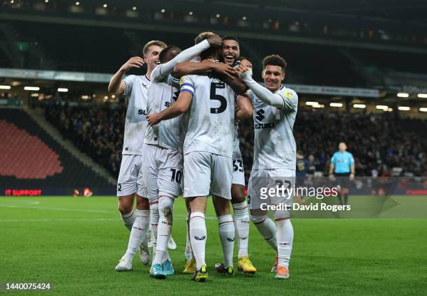 Warren O'Hora of Milton Keynes Dons celebrates with teammates after scoring their team's first goal during the Carabao Cup Third Round match between...