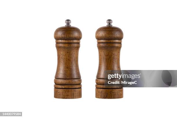 brown wood pepper mill and salt mill isolated on white - pepper mill stock pictures, royalty-free photos & images