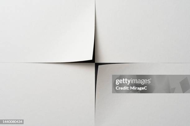cross shape paper corner cut out from white paper - cut or torn paper stock-fotos und bilder
