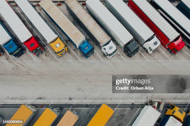 aerial shot of trucks parked at truck stop - truck stockfoto's en -beelden