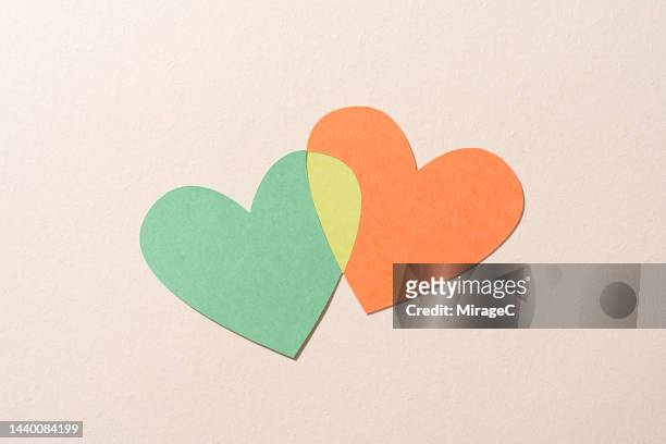 couple love hearts joined together, paper cut craft - two hearts stock-fotos und bilder