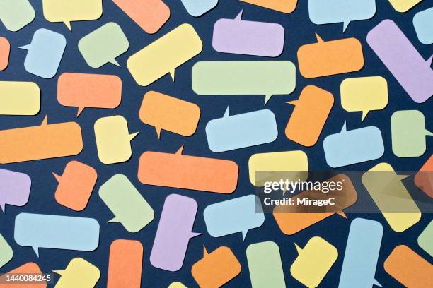 abundance of colorful paper speech bubbles on blue - fragebogen stock-fotos und bilder