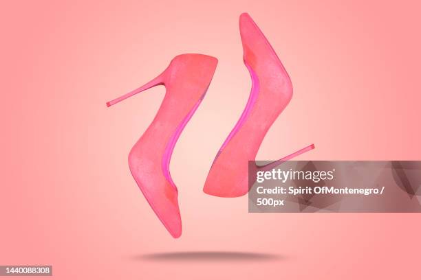 beautiful baby pink high heels against pink background - pink shoe stock-fotos und bilder