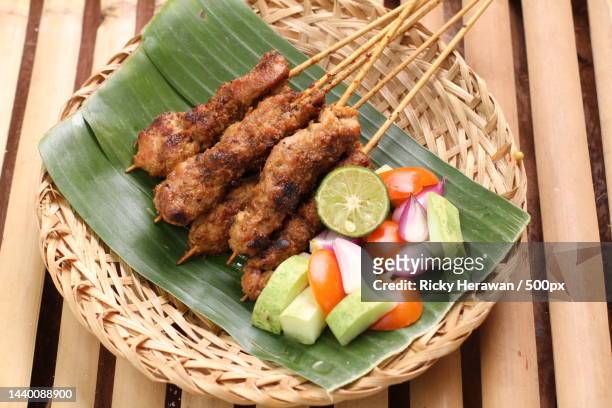 high angle view of fried chicken skewers with rice and sauce served on wooden table - ketupat stock pictures, royalty-free photos & images