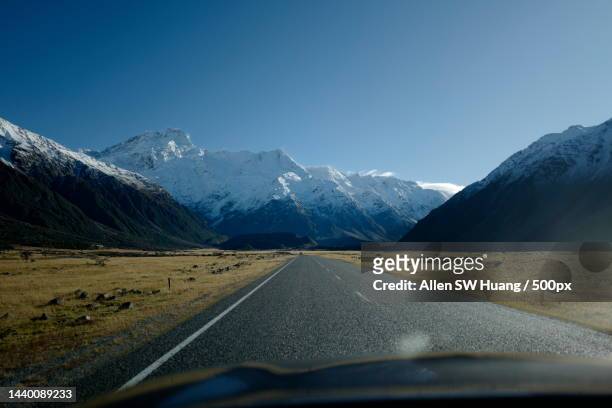 scenic view of road along snow capped mountainside,canterbury,new zealand - allen sw huang stock pictures, royalty-free photos & images