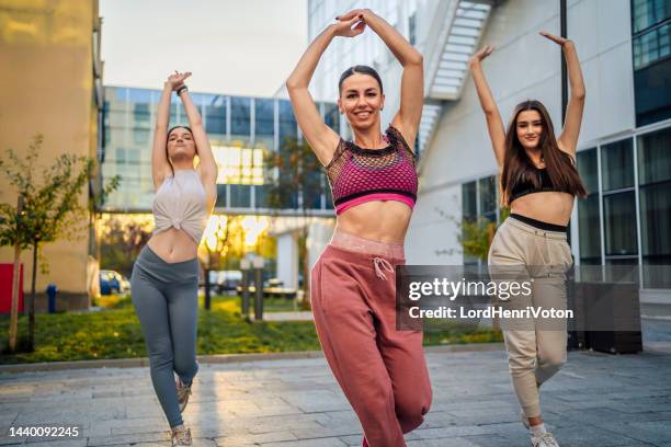 team of dancers performing outdoors - dance troupe stock pictures, royalty-free photos & images