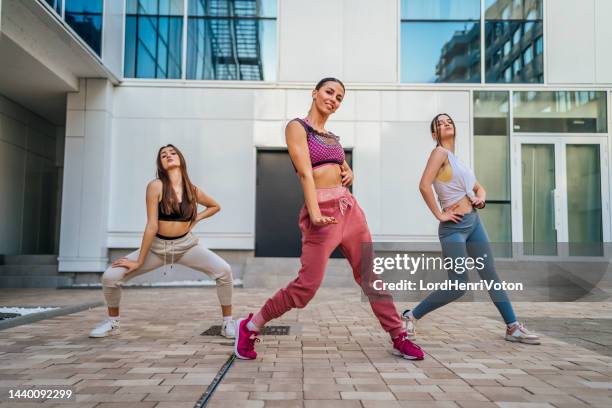 three female dancers outdoors - dance troupe stock pictures, royalty-free photos & images