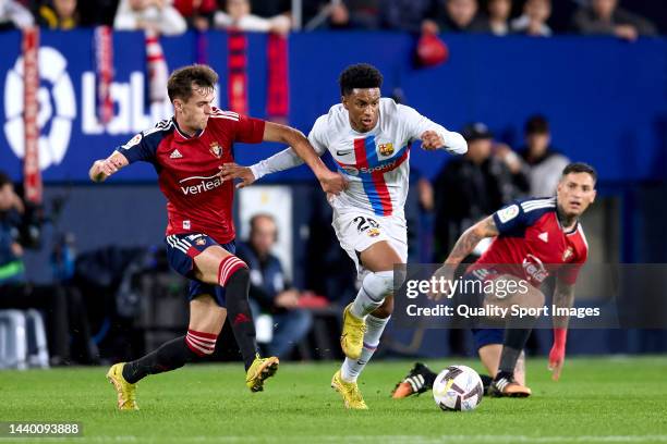 Aimar Oroz of CA Osasuna hurt for the ball with Alex Balde of FC Barcelona during the LaLiga Santander match between CA Osasuna and FC Barcelona at...