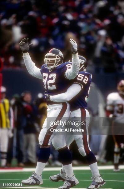 Defensive End Michael Strahan of the New York Giants has a Sack in the game between the Washington Redskins vs the New York Giants at Giants Stadium...