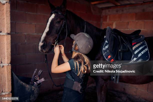 beautiful girl getting ready to ride her horse - hobby horse stock pictures, royalty-free photos & images