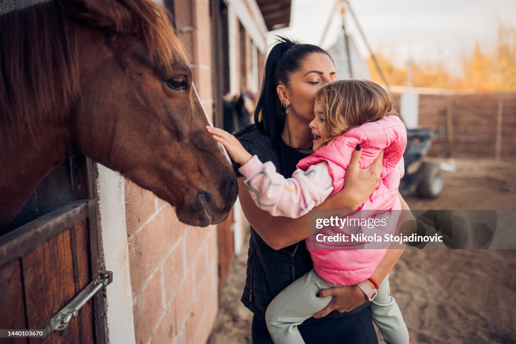 Mother and daughter with a horse