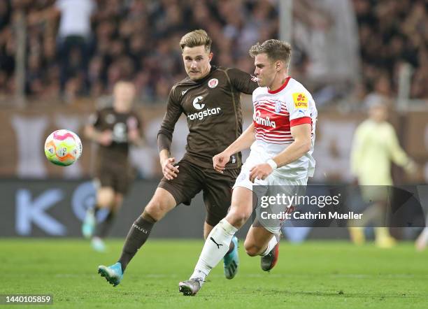 Simon Lorenz of Holstein Kiel is challenged by Johannes Eggestein of FC St. Pauli during the Second Bundesliga match between FC St. Pauli and...