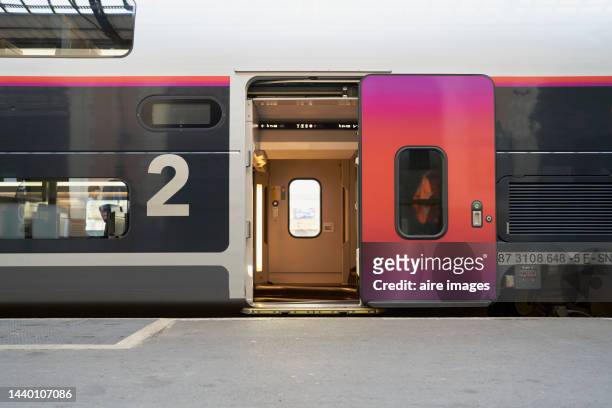train door at the station open waiting for people to enter seen from a corner with glass windows - inside of train stock pictures, royalty-free photos & images