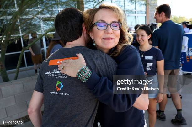 Former Rep. Gabby Giffords , the wife of Sen. Mark Kelly , hugs a campaign volunteer as they listen to Kelly speak on Election Day on November 08,...