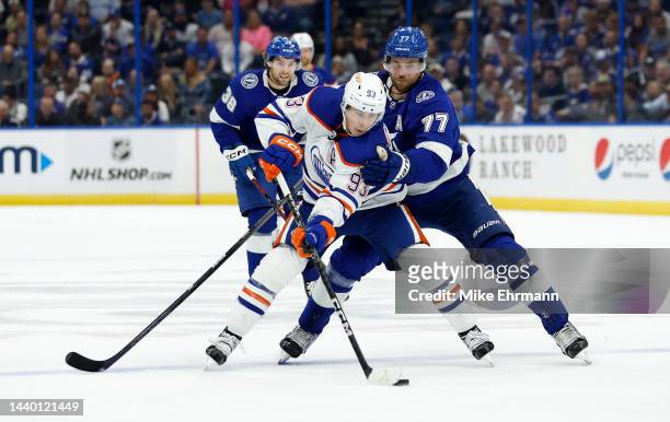 Ryan Nugent-Hopkins of the Edmonton Oilers and Victor Hedman of the Tampa Bay Lightning fight for the puck during a game at Amalie Arena on November...