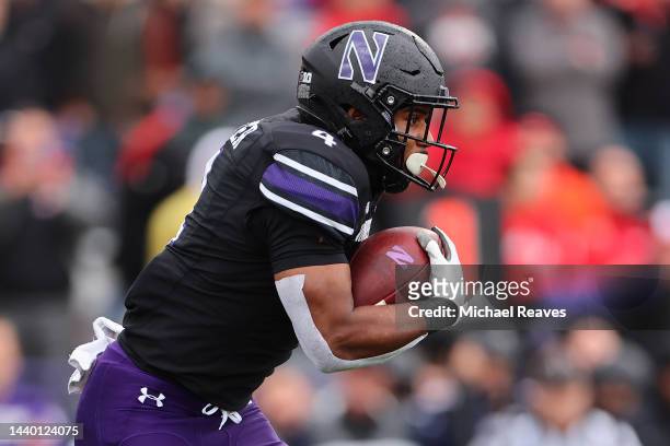 Cam Porter of the Northwestern Wildcats runs with the ball against the Ohio State Buckeyes during the first half at Ryan Field on November 05, 2022...