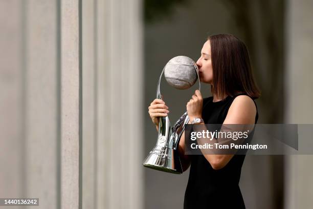 Iga Swiatek of Poland poses for a photo with the Chris Evert WTA Year-End World No. 1 Singles player trophy following the 2022 WTA Finals, part of...
