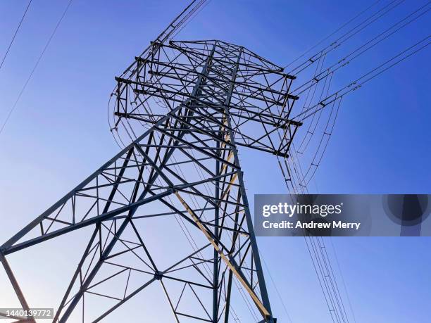 electricity transmission tower violet blue sky - electrical component stock pictures, royalty-free photos & images