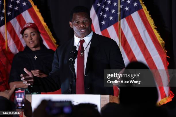 Republican U.S. Senate candidate Herschel Walker speaks to supporters as his wife Julie Blanchard looks on during an election night event on November...