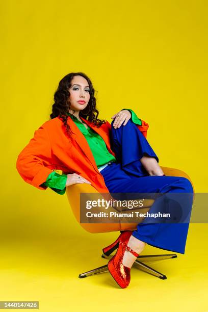 beautiful woman dresses in colorful outfit - multi colored blazer stockfoto's en -beelden