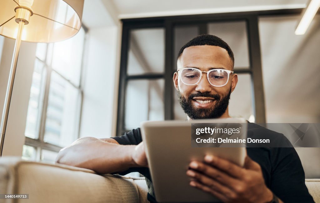 Black man, tablet and smile for social media post, shopping online or browsing internet creative content at home. Young africa american happy, relax and calm on tech digital app on device