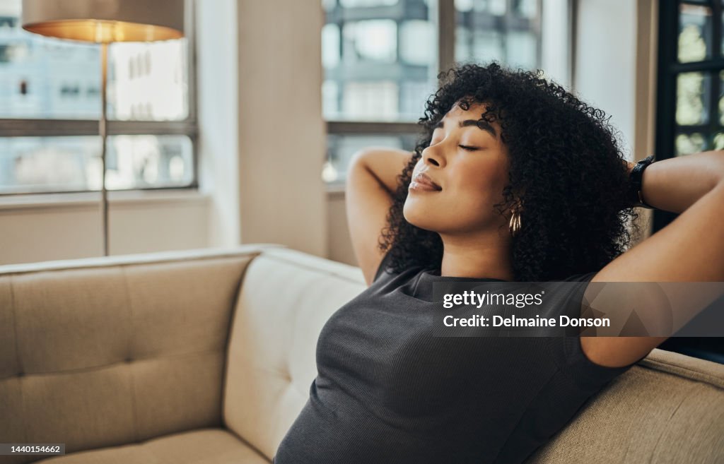 Relax, rest and woman on sofa with eyes closed at home in city apartment. Happy, healthy and stress free, girl from Brazil smiling, relaxing and thinking alone on couch, calm zen and happy nap time.