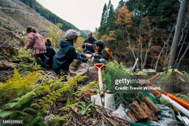 community volunteers gathering at a tree planting event - sembrar fotografías e imágenes de stock