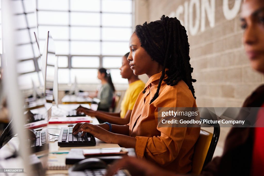 Working In College Young Female College Student Working During A Computer Class High-Res ...