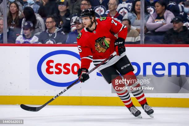 Alec Regula of the Chicago Blackhawks keeps an eye on the play during first period action against the Winnipeg Jets at the Canada Life Centre on...